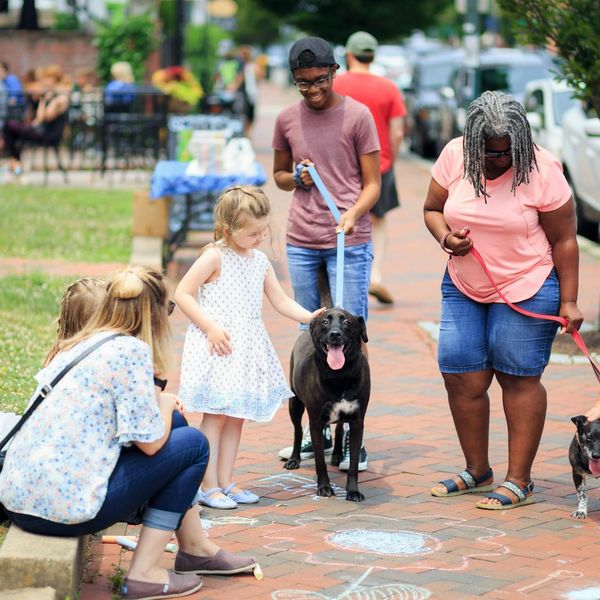 Diverse group of people smiling and looking relaxed after a group activity.